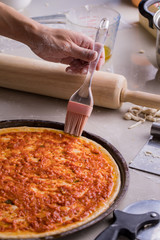 Tomato top topping pizza during baking.