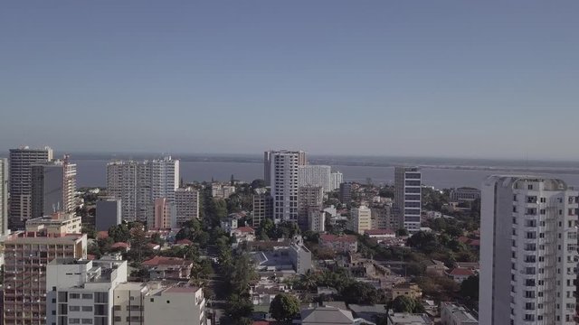 Downtown of Maputo with skyscrapers and car traffic in the afternoon, capital city of Mozambique