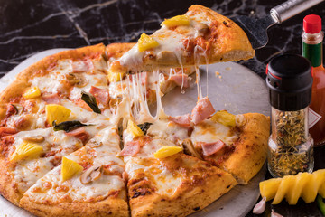 The pizza slices with different toppings in tray on the table.