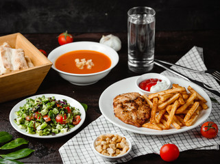 tomato soup, vegetable salad and chicken with french fries