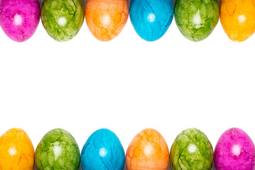 Two borders of easter eggs in different colors on white background