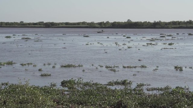 Fisherman standing in his boat on Incomati River, Macaneta Beach, Maputo Province, Mozambique