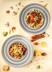 two portion of penne and linquini on the table