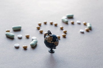 Small globe on the background of the inscription from pills sos. Coronavirus concept