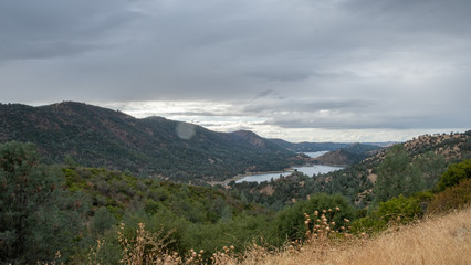 view on a fjord in north california, with a forest and cloudy sky