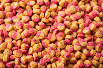 Pelleted compound fish feed background, wheatfeed pellets. Top view background