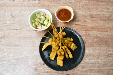 pork satay with sweet peanut sauce and pickled vegetable cup
