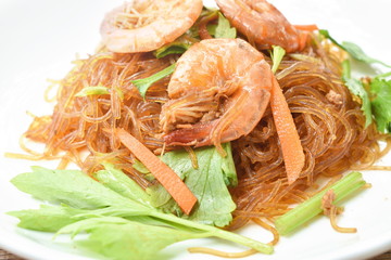baked glass noodles with slice carrot and celery topping shrimp on plate