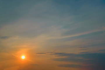 Obraz premium The sky at sunset. Cumulus clouds lit by the rays of the setting sun.