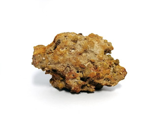 Laterite stone on white background. Laterite is a soil and rock type rich in iron and aluminium and is commonly considered to have formed in hot and wet tropical areas.