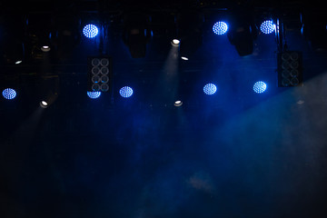 Fototapeta na wymiar stage light with colored spotlights and smoke, concert scene 