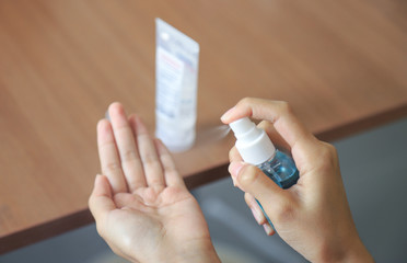 Hand using alcohol liquid to clean from bacteria nad Corona virus in daily life 