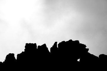 The silhouette of the cliffs of Kukenan tepui or Mount Roraima with clouds and sky. Black and white composition. Gran Sabana. Venezuela 2015.