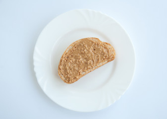 Plate with peanut butter sandwich isolated on white background