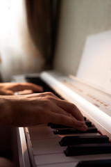 Obraz premium the musician plays the photo piano, hands on the keyboard, male hands
