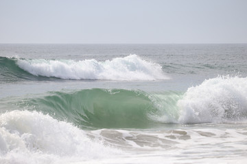 Closeup of curling ocean waves nearing the beach