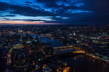 Elevated view of The City of London on a cloudy Spring night. Grained.