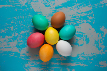 Colored easter eggs on blue shabby background with scratches