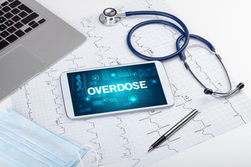 Tablet pc and medical stuff with OVERDOSE inscription, prevention concept