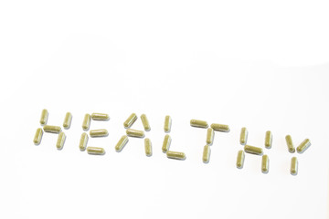 Health written with green pills (diagonal down)