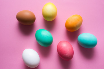 Fototapeta na wymiar Colored easter eggs on pink background