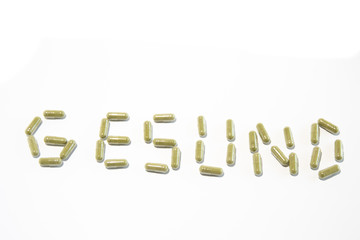 Health written with green pills (german)