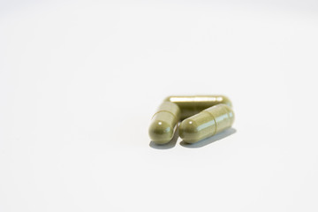 Three green pills (gel capsules with moringa)