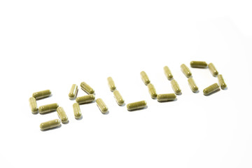 Health written with green pills (spanish, diagonal up)