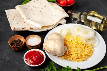 products for the preparation of burritos or shawarma on a stone background