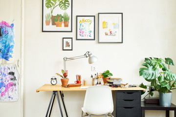 Artist's workplace for working from home with watercolor paints, brushes and sketchbooks. Place for design, illustration and creativity.