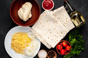 products for the preparation of burritos or shawarma on a stone background