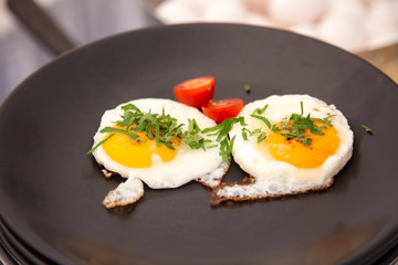 fried eggs with bacon and vegetables