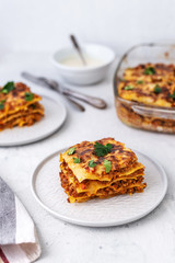 Delicious homemade italian Lasagna with bachamel sauce on gray background. Hot tasty Lasagna with cheese
