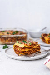 Delicious homemade italian Lasagna with bachamel sauce on gray background. Hot tasty Lasagna with cheese