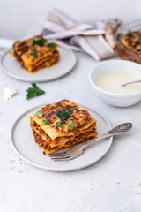Delicious homemade italian Lasagna with bachamel sauce on gray background. Hot tasty Lasagna with cheese