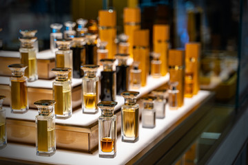 Blurred beautiful shop in shopping malls. Big sales on Black Friday for Christmas. The large perfumery shop of elite perfumery and cosmetics is washed out. Rack with shelves in a large drogeria