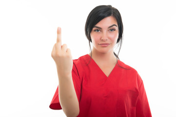 Portrait of young attractive female nurse showing obscene gesture