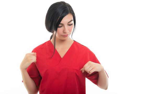 Portrait of young attractive female nurse checking pocket