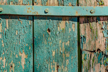 Old boards covered with peeling green paint