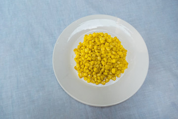 corn on a plate on a tablecloth