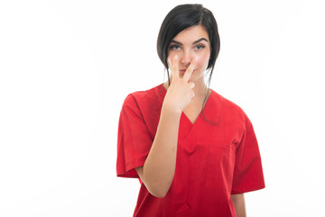 Portrait of attractive female nurse making watch me gesture