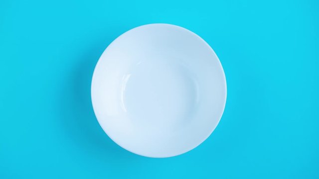 Fresh strawberries in bowl on retro background. Stop motion animation. From empty to full. Healthy food, summer berries