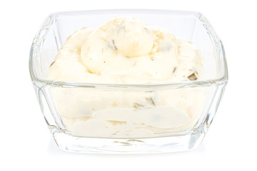 Tartar sauce with onions and pickled cucumbers in a small transparent glass square bowl isolated on white background