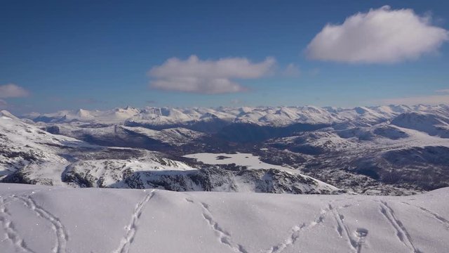 View over beautiful mountains and animal tracks in the snow