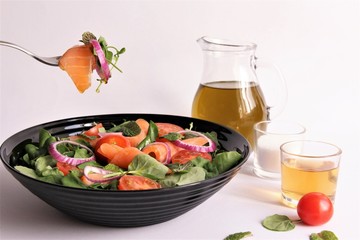 Folk pick up salmon salad healthy Mediterranean salad  nutrients from proteins and vitamins Antioxidants weight lose menu. photo isolate on white front view 