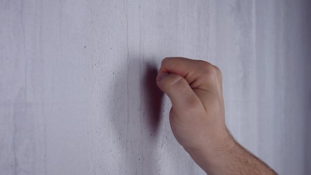 Male Knocks on a white wooden door with his hand. Debt and tax concept
