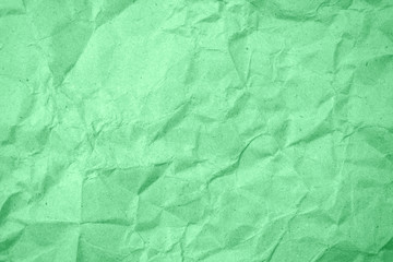 Green crumpled paper texture as background