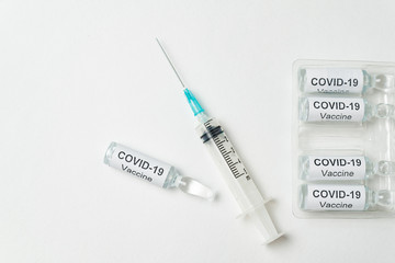 Vaccine and syringe injection. Ampoules with vaccine for coronavirus on white background.