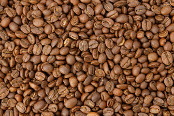 Aromatic roasted coffee beans background. Texture top view.