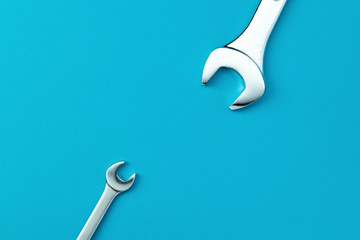 Wrenches on a blue background copy space top view. Service concept.